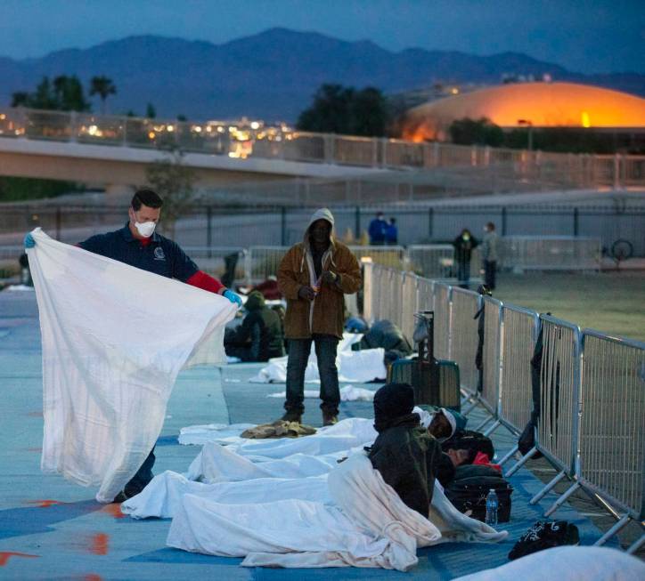 Volunteers provide extra blankets to the homeless at a temporary shelter at the upper parking l ...