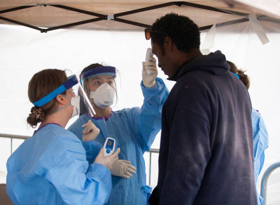 Touro University Nevada medical students screen for signs of the coronavirus at a temporary she ...