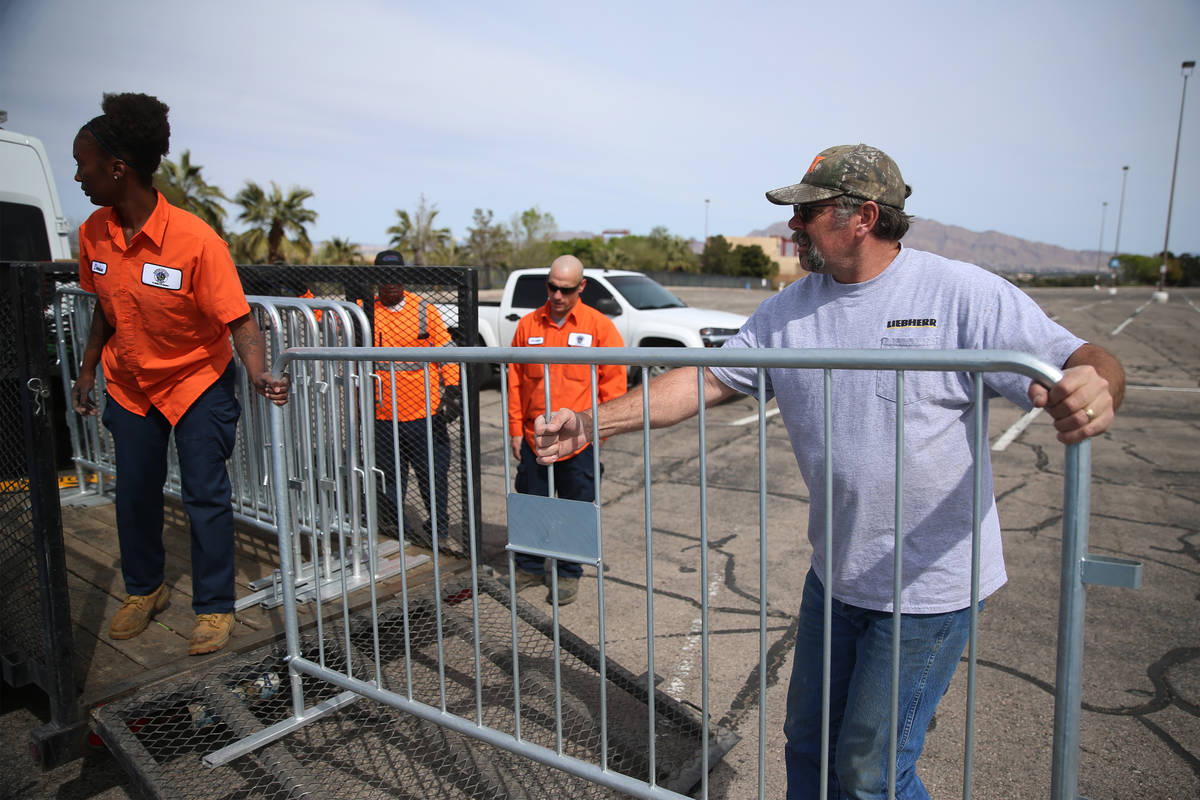 John Grul, right, volunteer with Teamsters Local 631, helps to set up barriers for a temporary ...