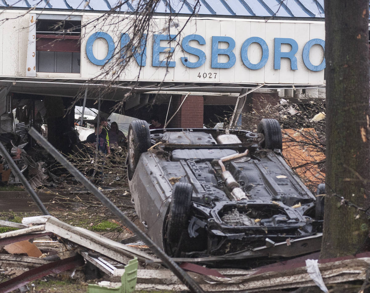 A vehicle lies upside down among other debris after a tornado Saturday, March 28, 2020, at Jone ...