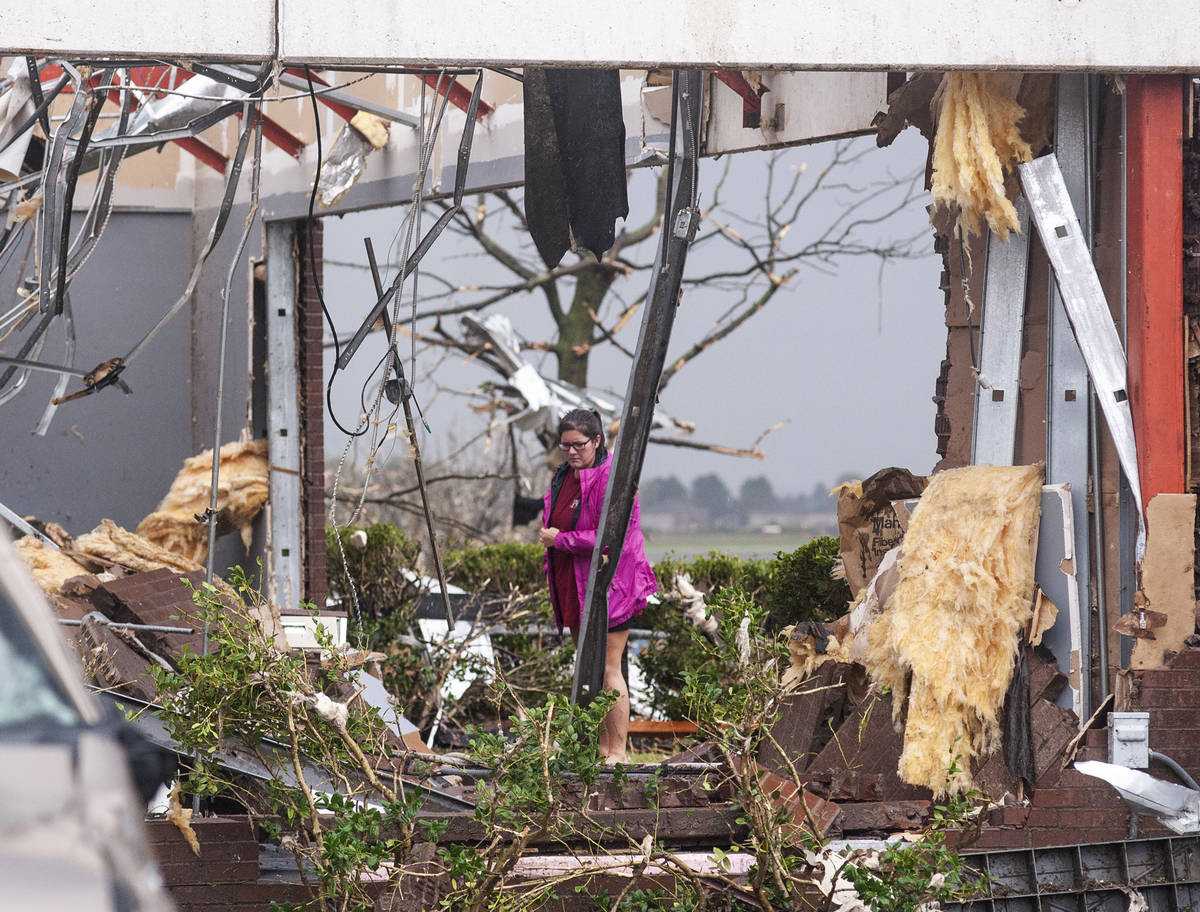 Katie Calaway surveys the damage to her office after a tornado touched down Saturday, March 28, ...