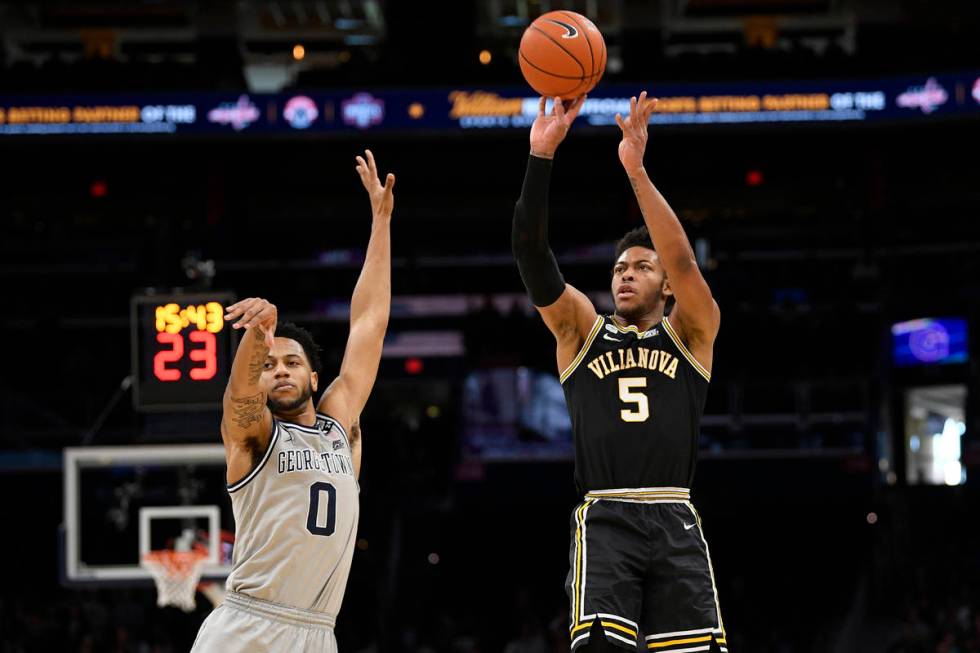 Villanova guard Justin Moore (5) shoots next to Georgetown guard Jahvon Blair (0) during the fi ...