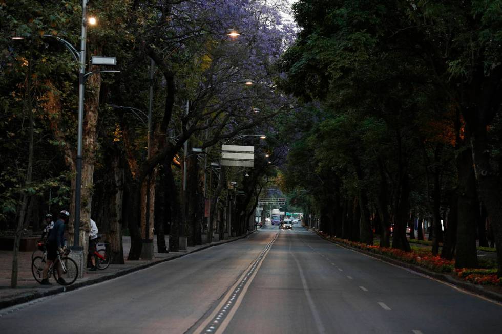 Little traffic is seen on the usually crowded Paseo de la Reforma in Mexico City, at dusk Satur ...