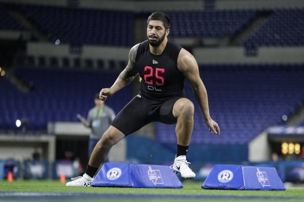 Iowa defensive lineman A J Epenesa runs a drill at the NFL football scouting combine in Indiana ...