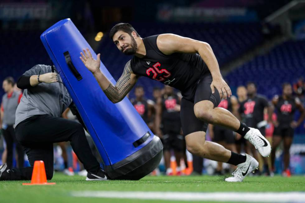 Iowa defensive lineman A J Epenesa runs a drill at the NFL football scouting combine in Indiana ...