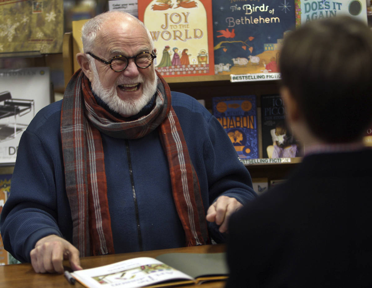 In this photo taken Sunday Dec. 1, 2013, Tomie dePaola laughs as he signs books at the Morgan H ...