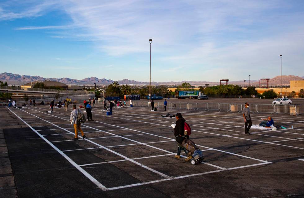 Homeless people enter a temporary shelter in the upper parking lot at Cashman Center due to the ...