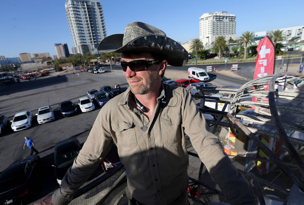 Tomas Toulee raises BalanceVille art car into the air at First Friday in the Arts District of d ...