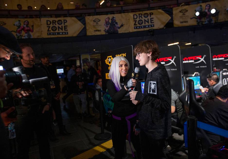 Nikolas Bruno, right, of Las Vegas, is interviewed after winning a game of Fortnite in the firs ...