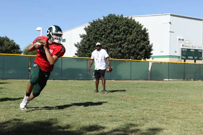 Rancho High School quarterback Ruben Vasquez runs with the football during a practice on a base ...