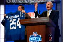 Former NFL receiver Paul Salata, right, announces the 254th overall pick of the NFL Draft, Satu ...