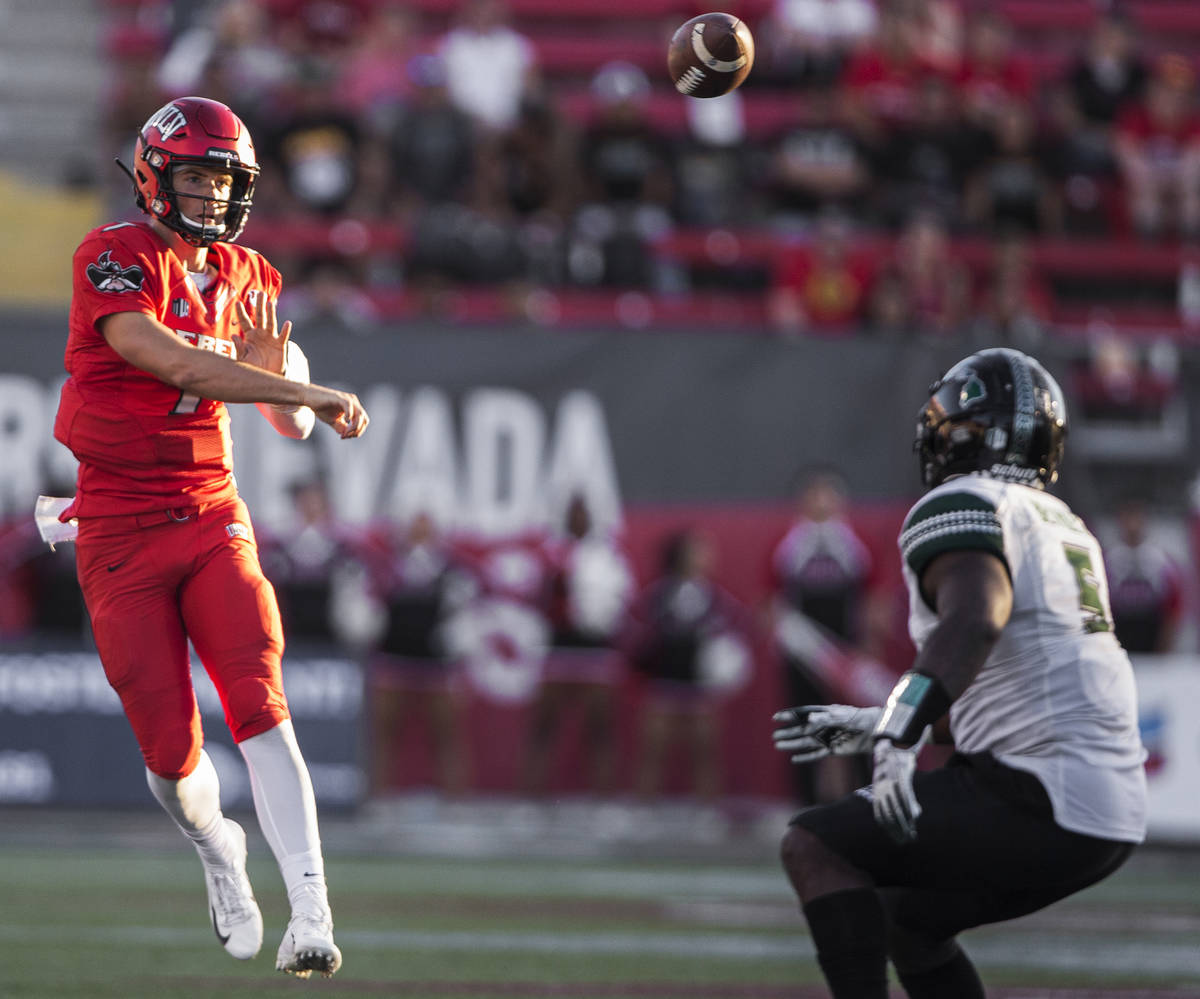 UNLV Rebels quarterback Kenyon Oblad (7) makes a throw on the run over Hawaii Warriors defensiv ...