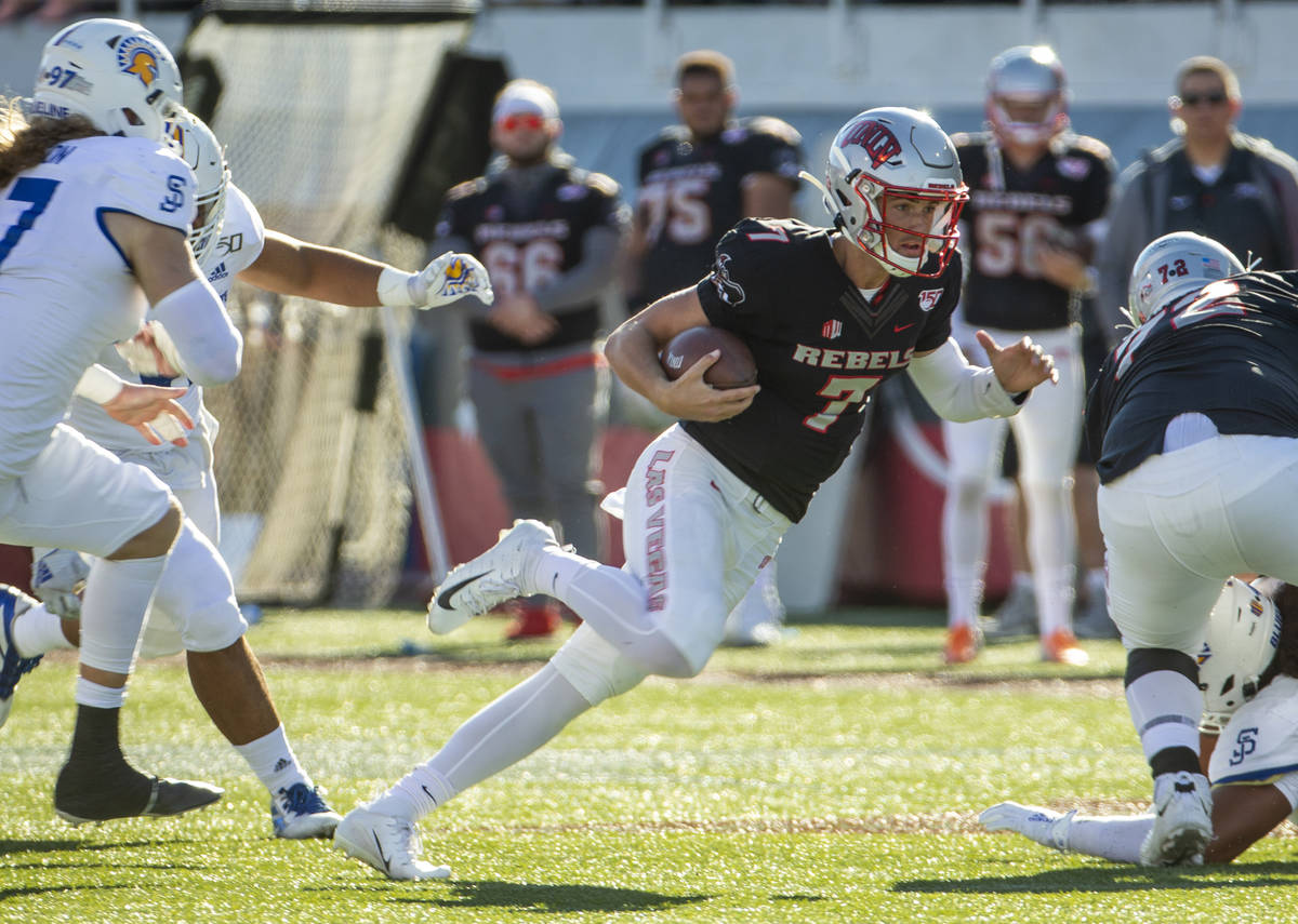 UNLV Rebels quarterback Kenyon Oblad (7) cuts up field through the San Jose State Spartans defe ...