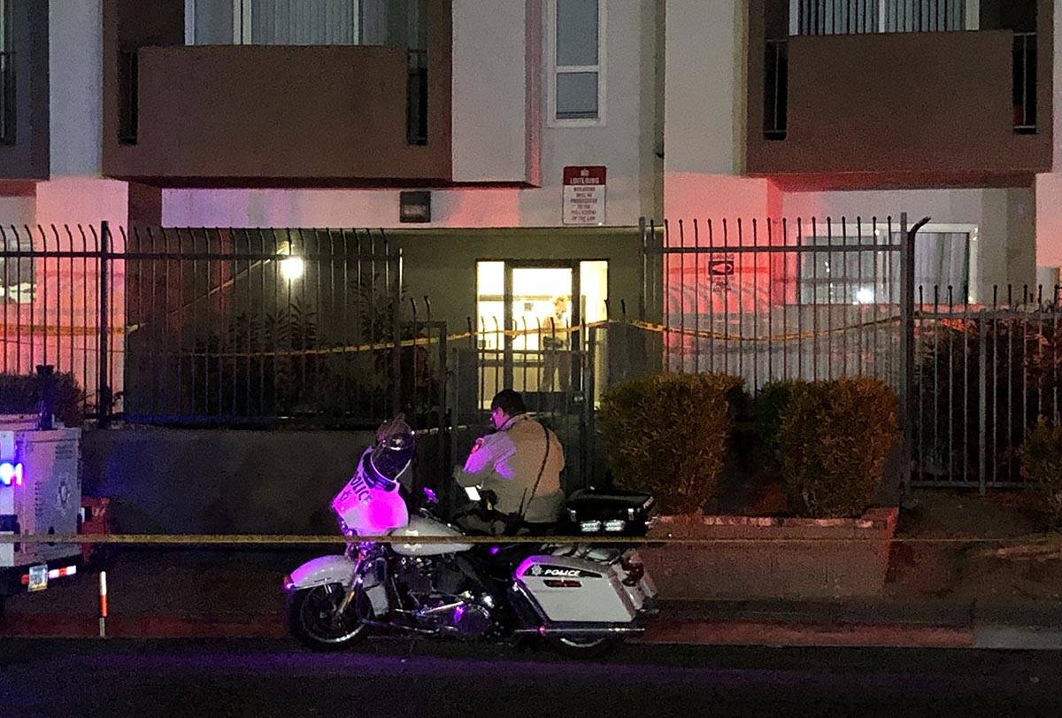 A Las Vegas Metropolitan Police Department motorcycle officer outside of an apartment building ...