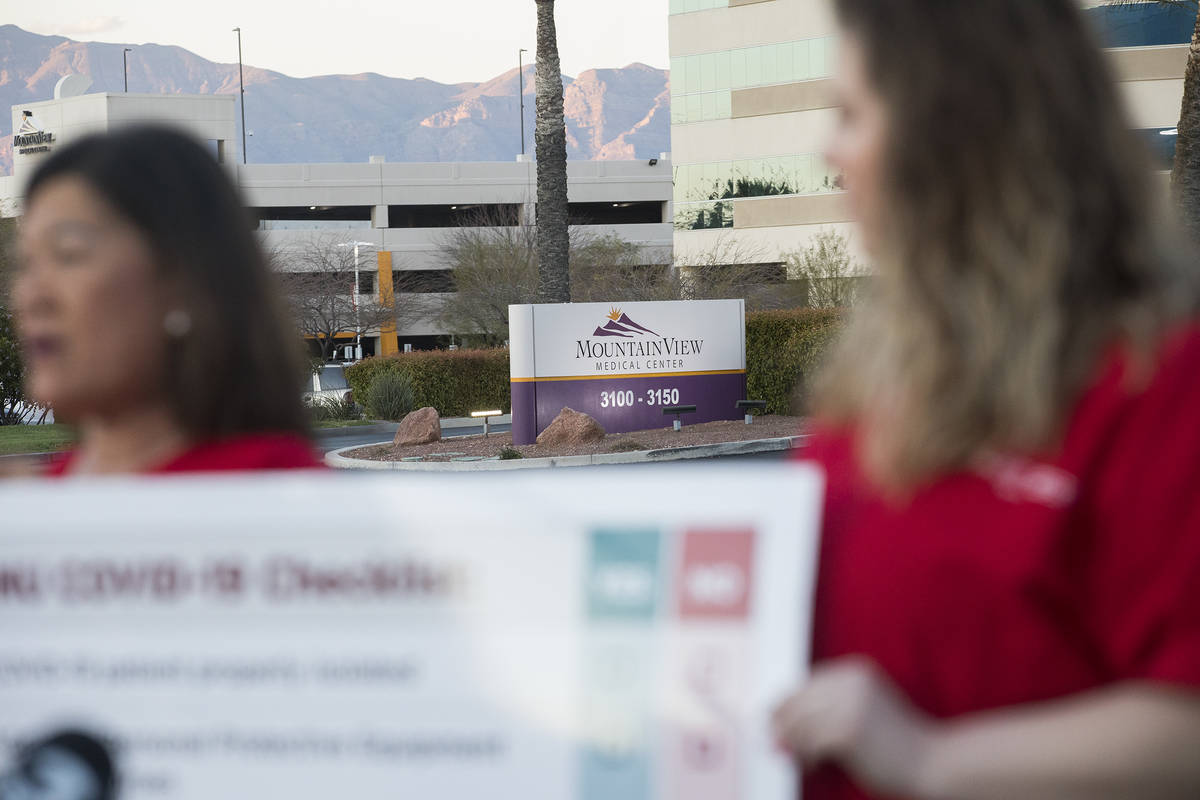 Dina Armstrong, a nurse and chief nurse for National Nurses Untied, left, addresses the media a ...