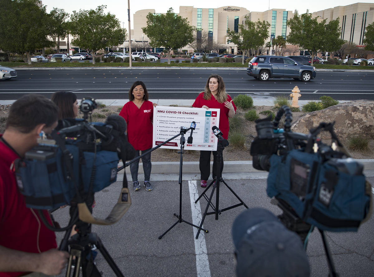 Dina Armstrong, a nurse and chief nurse for National Nurses Untied, left, addresses the media a ...