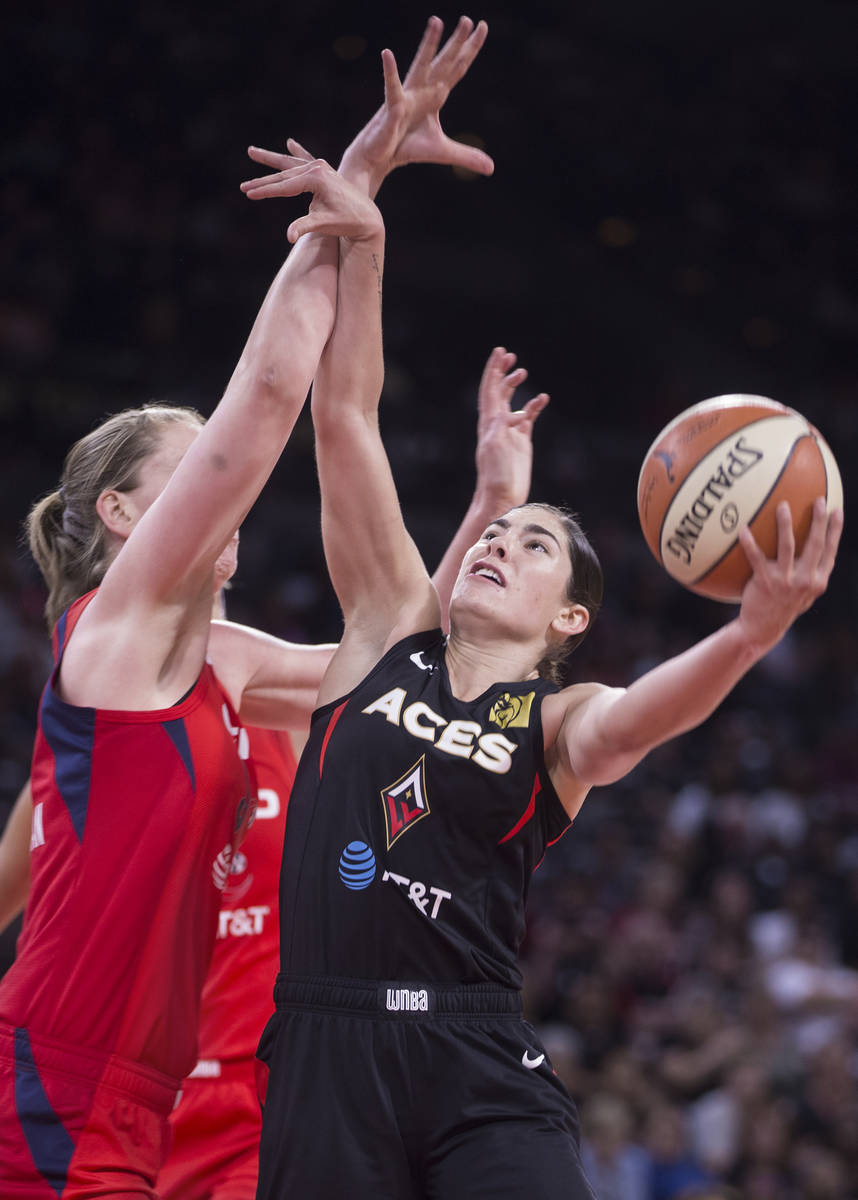 Las Vegas Aces guard Kelsey Plum (10) drives past Washington Mystics center Emma Meesseman (33) ...