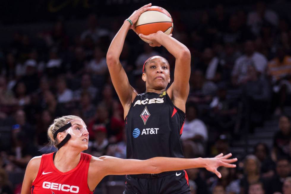 Las Vegas Aces center A'ja Wilson (22) shoots over Washington Mystics forward Elena Delle Donne ...