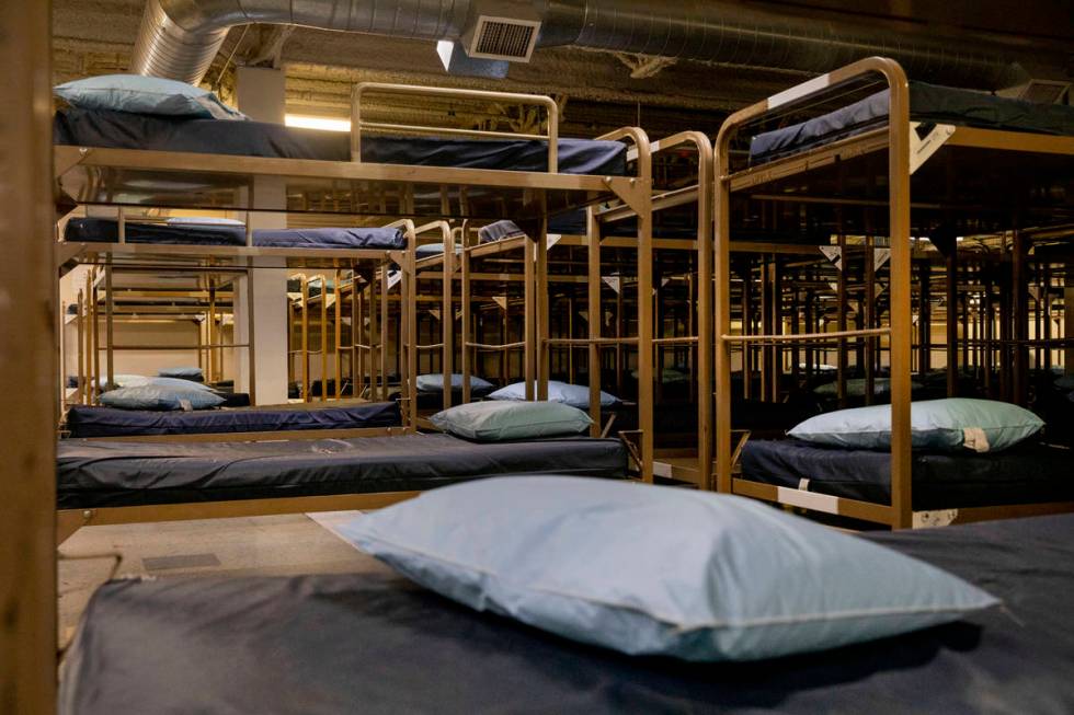 Rows of bunkbeds are seen with mattresses removed from multiple in effort to practice social di ...