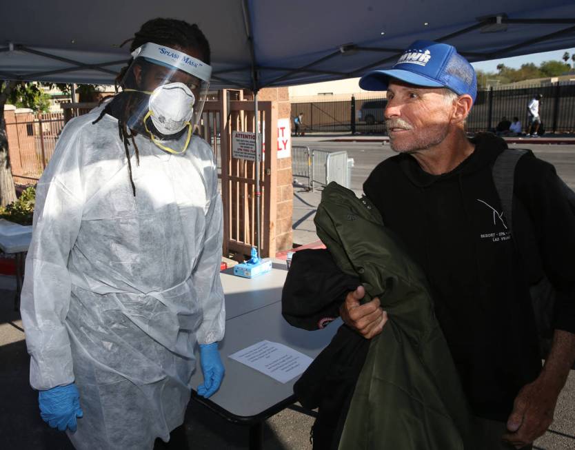 Chronic Homeless Case Manager Dave Brabham, left, screens Randall White, 61, on Foremaster Lane ...