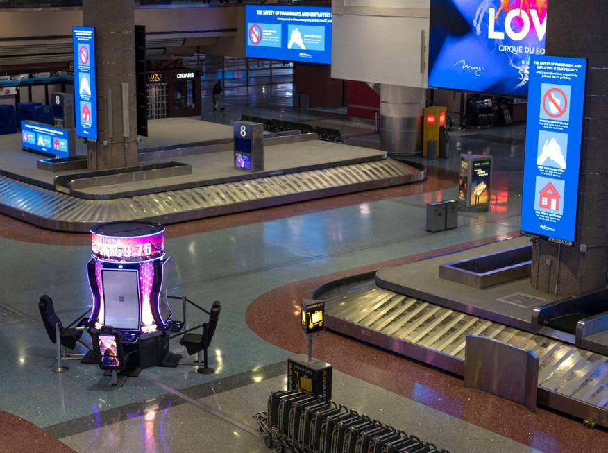 Baggage carousels sit unused at McCarran International Airport on Wednesday, April 1, 2020, in ...