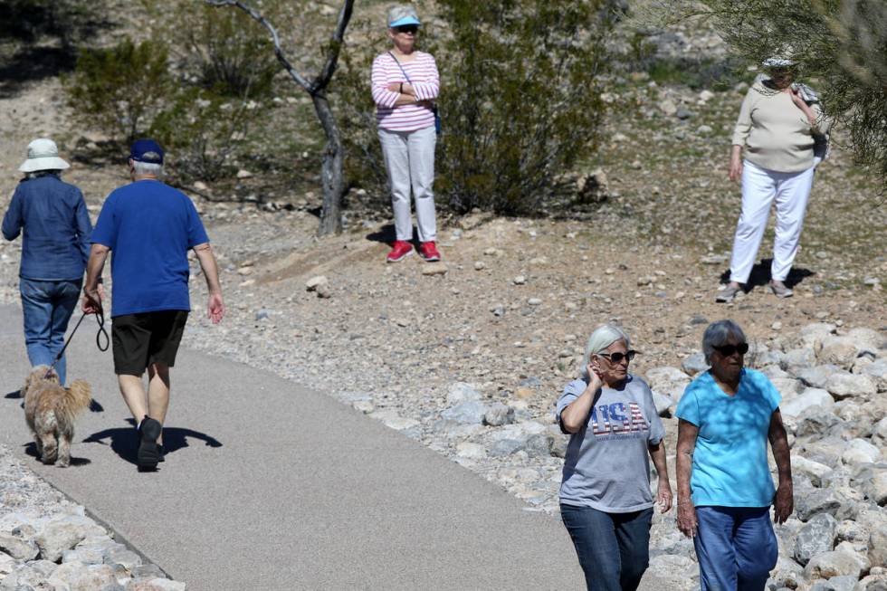 Arlene Gawne, 73, right rear, and Martha Hill, 71, step off the path to let Mary Scharn, 84, ri ...