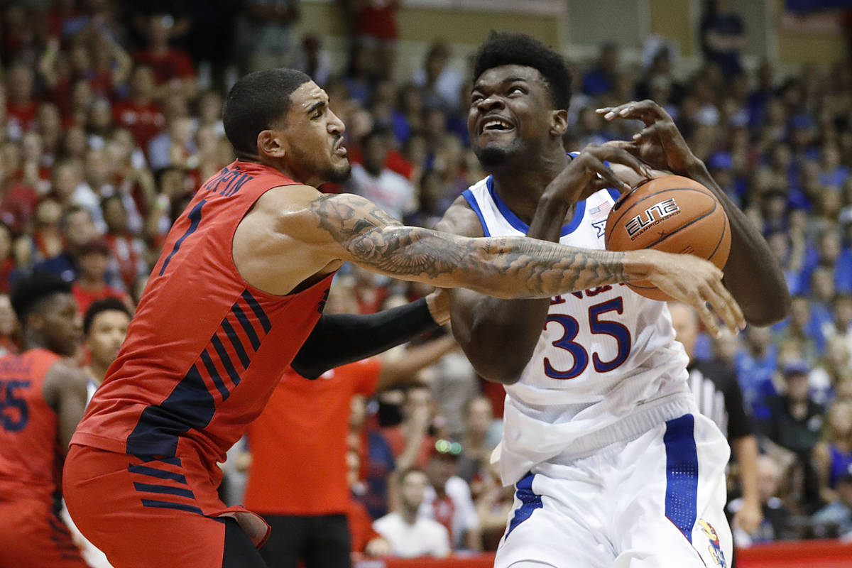 In this Nov. 27, 2019, file photo, Dayton forward Obi Toppin (1) knocks the ball away from Kans ...