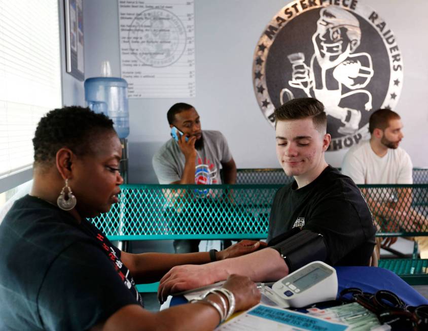 Southern Nevada Health District volunteer Tracey Johnson-Glover, a registered nurse, measures b ...