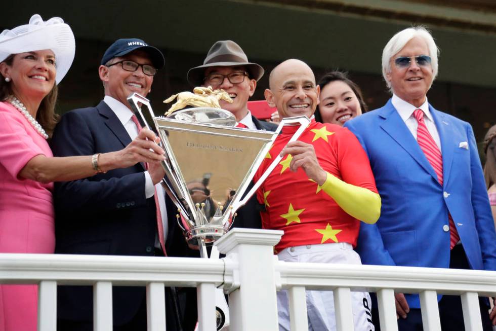 Jockey Mike Smith, second from right, trainer Bob Baffert, right, and owners Kenny Trout, secon ...