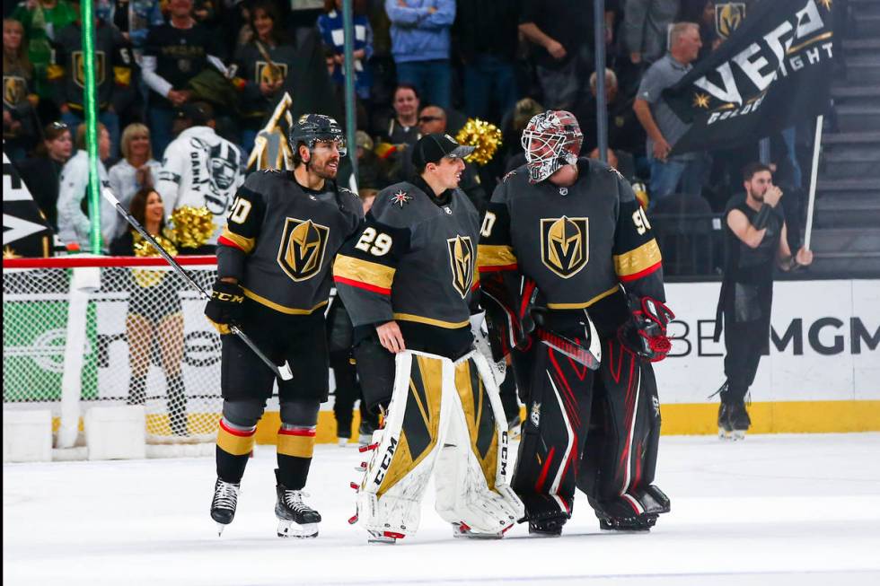 Golden Knights goaltenders Marc-Andre Fleury (29) and Robin Lehner (90) talk alongside Chandler ...