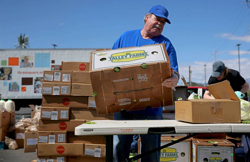 Three Square Food Bank volunteer John Castillo organizes food to give out at Palace Station Cas ...