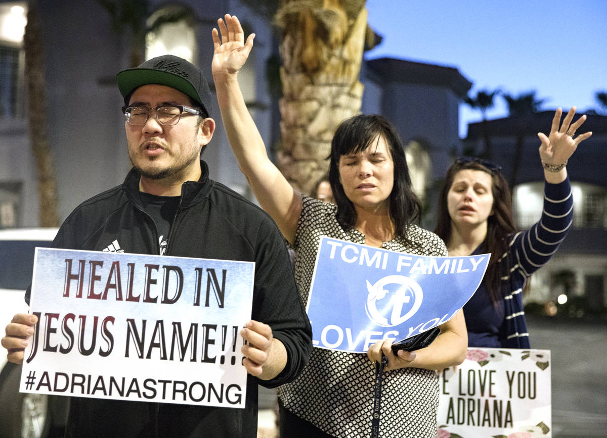 Corey Huh, from left, prays for his wife who is in the hospital with a type of muscle cancer ne ...