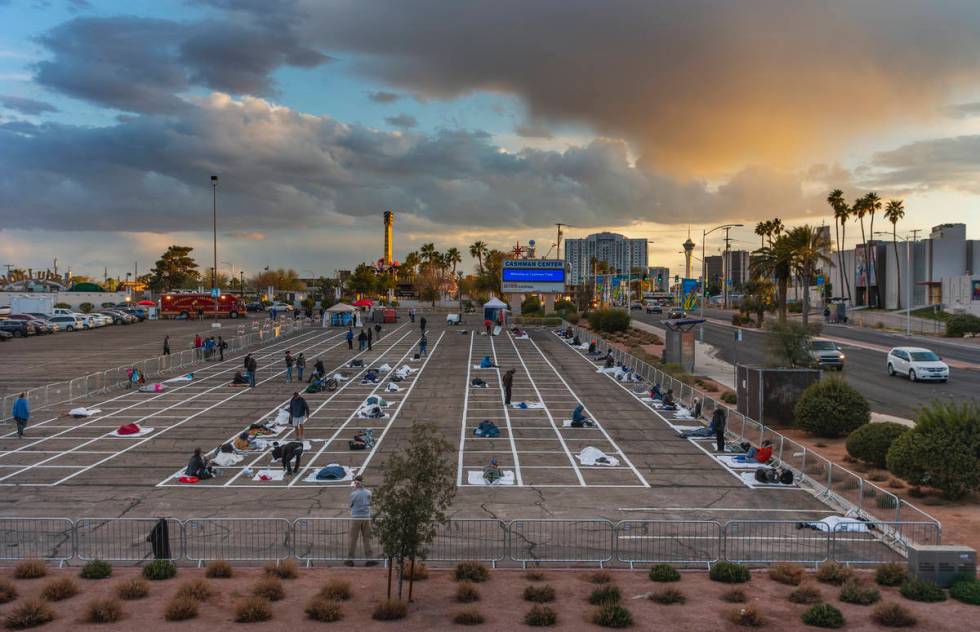 Homeless people settle in for the night with social distancing at the temporary shelter in the ...