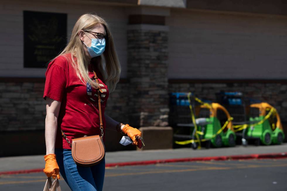 Local teacher Larissa Ellison wears a mask and gloves after getting groceries at Smith's Food a ...