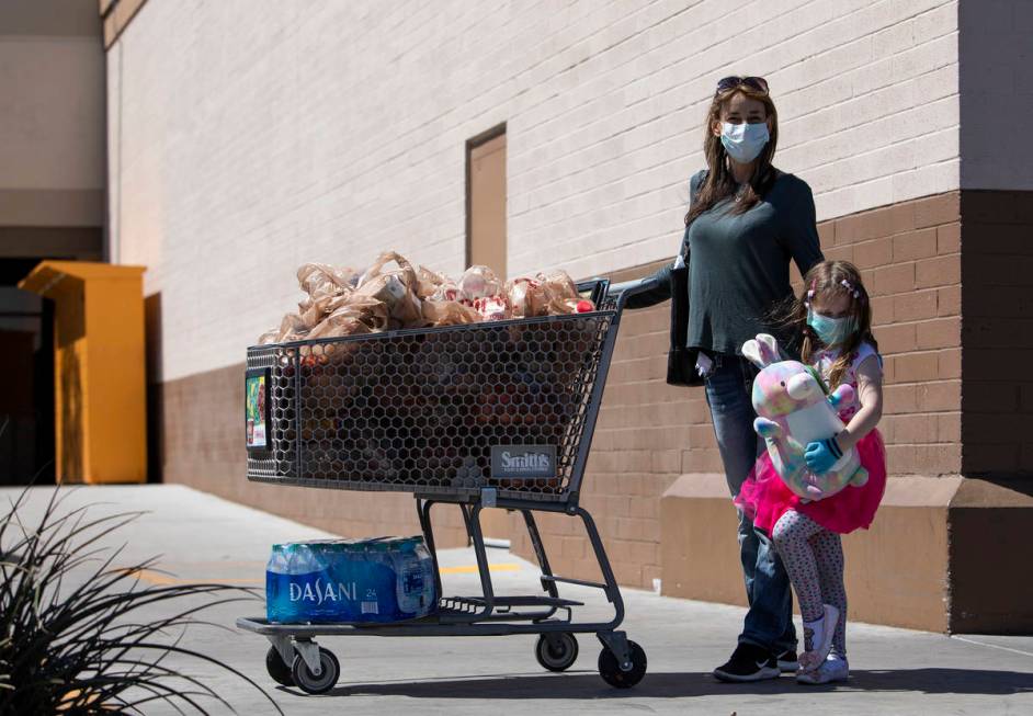 Leslie Attisani and her daughter Lily Attisani wore masks and gloves to their grocery store tri ...