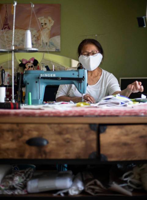 Alia Berry tells how she sews masks, meant to protect people from COVID-19, at her home on Frid ...