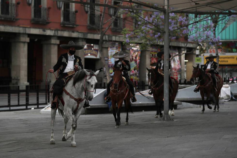 Mexican police dressed as charros patrol the popular Garibaldi square now empty of visitors in ...