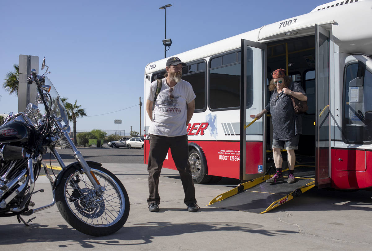 Todd Henke, left, and Debbie Holmgren, right, exit the bus before heading into Walmart on Satur ...