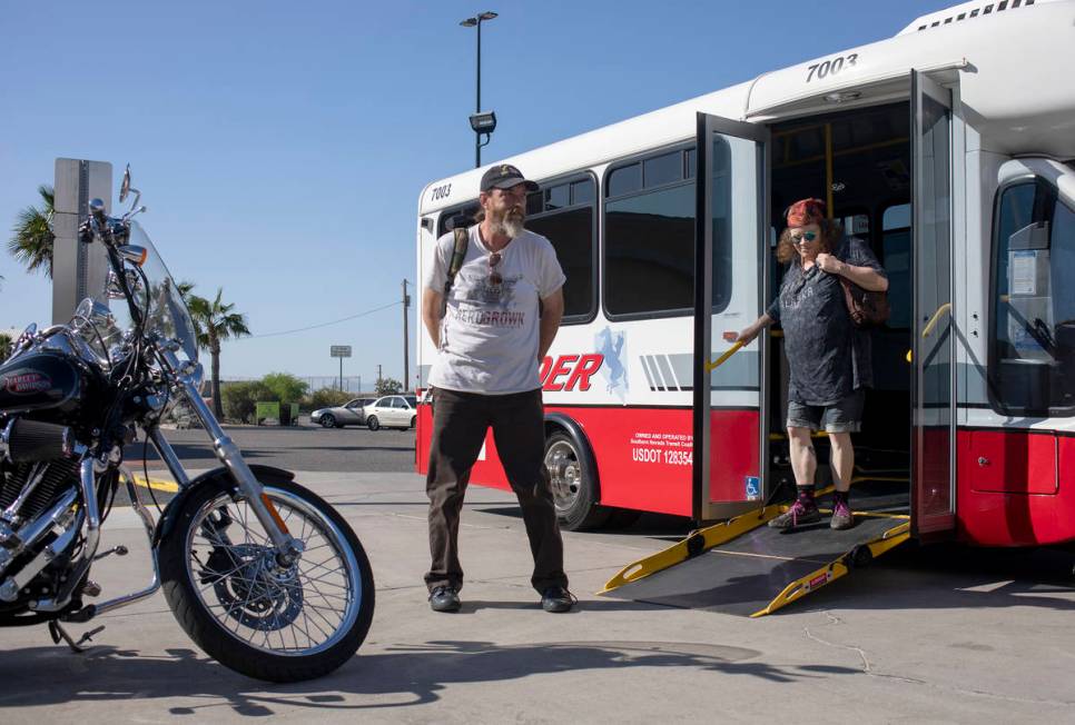 Todd Henke, left, and Debbie Holmgren, right, exit the bus before heading into Walmart on Satur ...