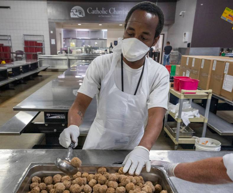 Kevin Terry helps package a dish for Meals on Wheels, at Catholic Charities of Southern Nevada ...