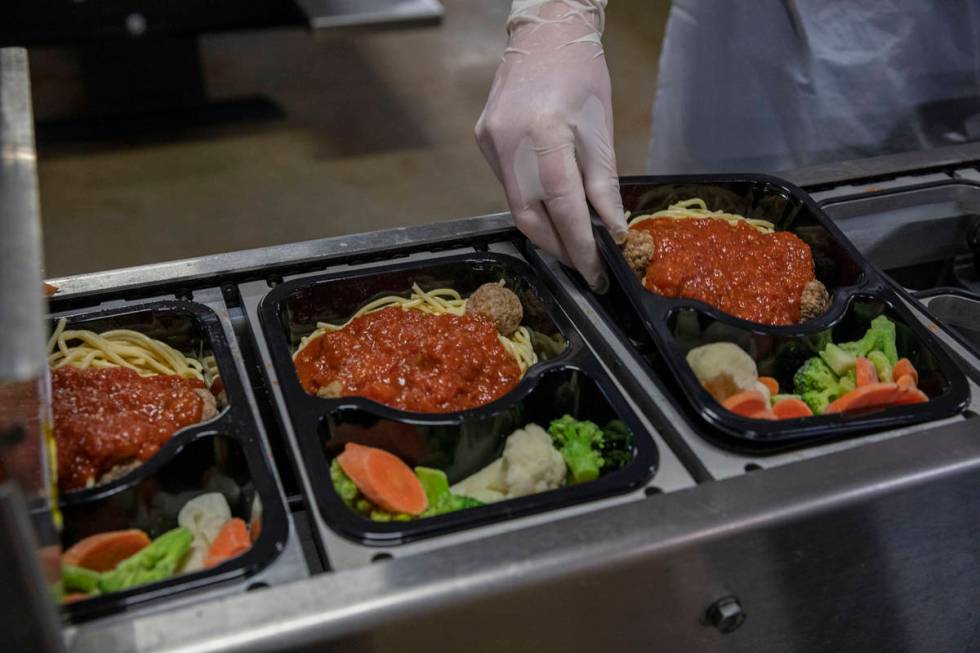 Meals on Wheels spaghetti and meatball dishes are packaged at Catholic Charities of Southern Ne ...