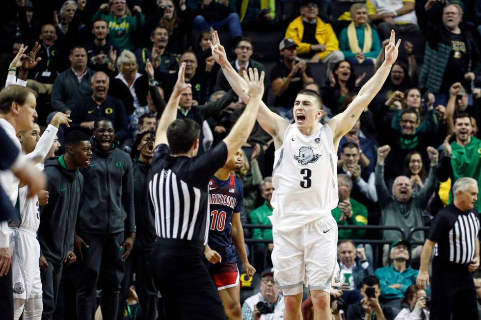 FILE - In this Jan. 9, 2020, file photo, Oregon's Payton Pritchard (3) celebrates a three-point ...