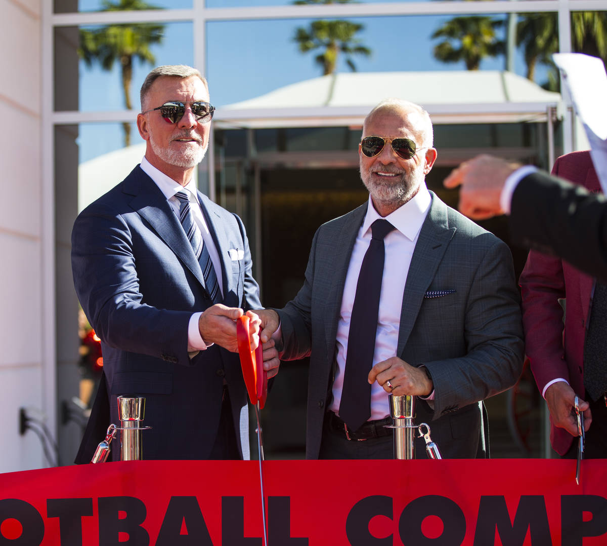 Frank Fertitta III, left, and Lorenzo Fertitta, prepare to cut the ribbon for the Fertitta Foot ...