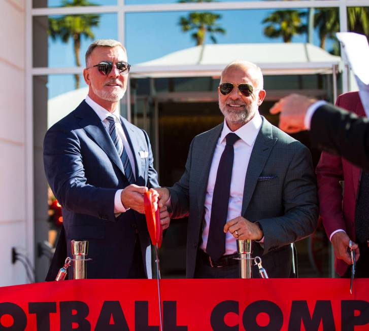 Frank Fertitta III, left, and Lorenzo Fertitta, prepare to cut the ribbon for the Fertitta Foot ...