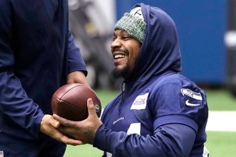 Seattle Seahawks running back Marshawn Lynch smiles during warmups at the NFL football team's p ...