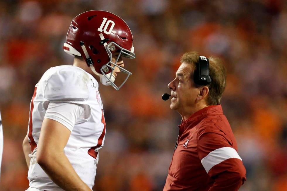 Alabama quarterback Mac Jones (10) talks with head coach Nick Saban during the second half of a ...