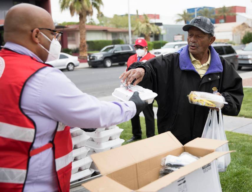 Jawan Mullen, vocational and residential services coordinator for the Salvation Army, hands out ...