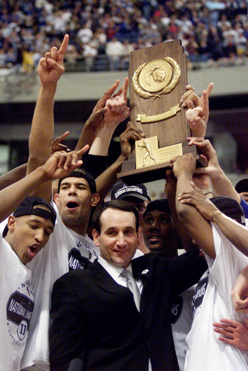 FILE - In this April 2, 2001, file photo, Duke coach Mike Krzyzewski and his Blue Devils hoist ...