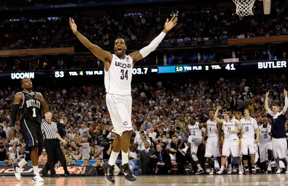 Connecticut's Alex Oriakhi celebrates after beating Butler 53-41 at the men's NCAA Final Four c ...