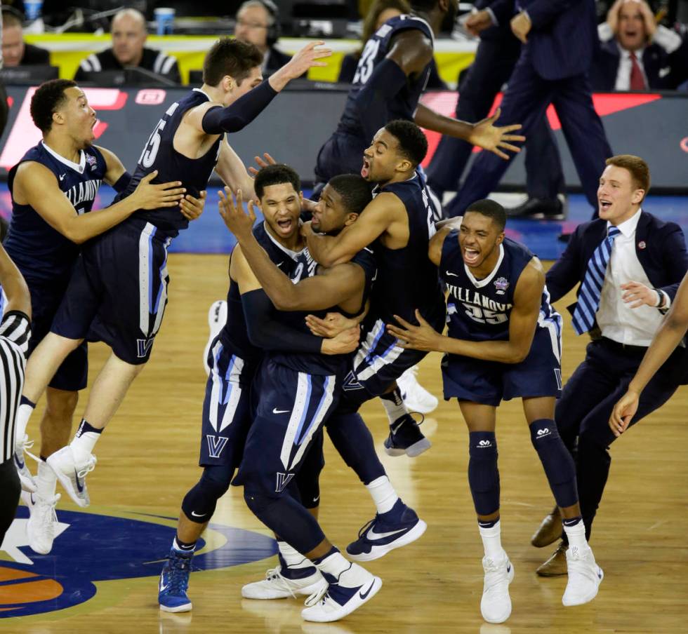 FILE - In this April 4, 2016, file photo, Villanova players celebrates after Kris Jenkins, cent ...